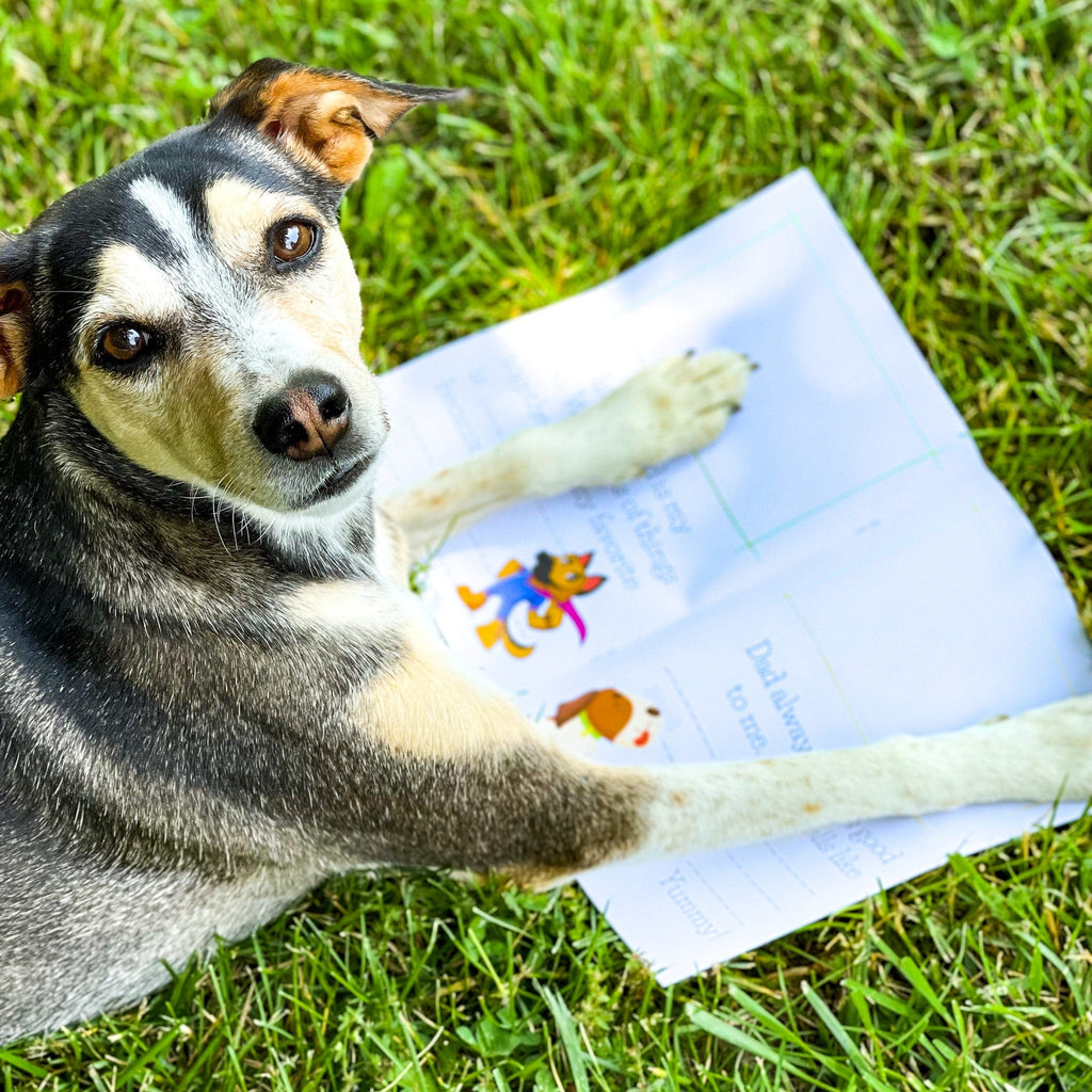 dog on grass with paws opening kids book 