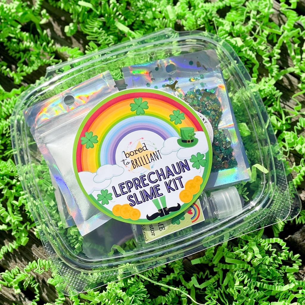 container with leprechaun slime kit on a bed of green grass, logo of leprechaun slime on container