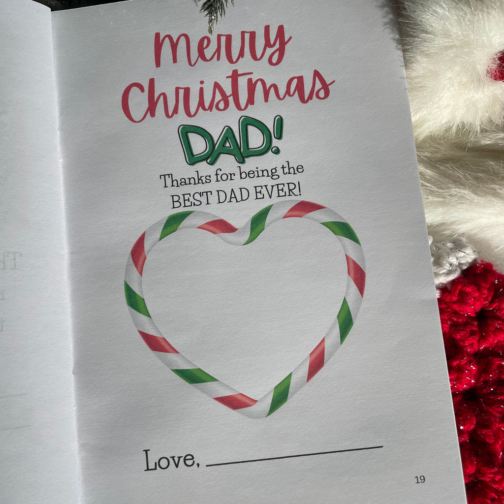 'Merry Christmas Dad' book interior page with festive illustrations on a background with snow and stocking