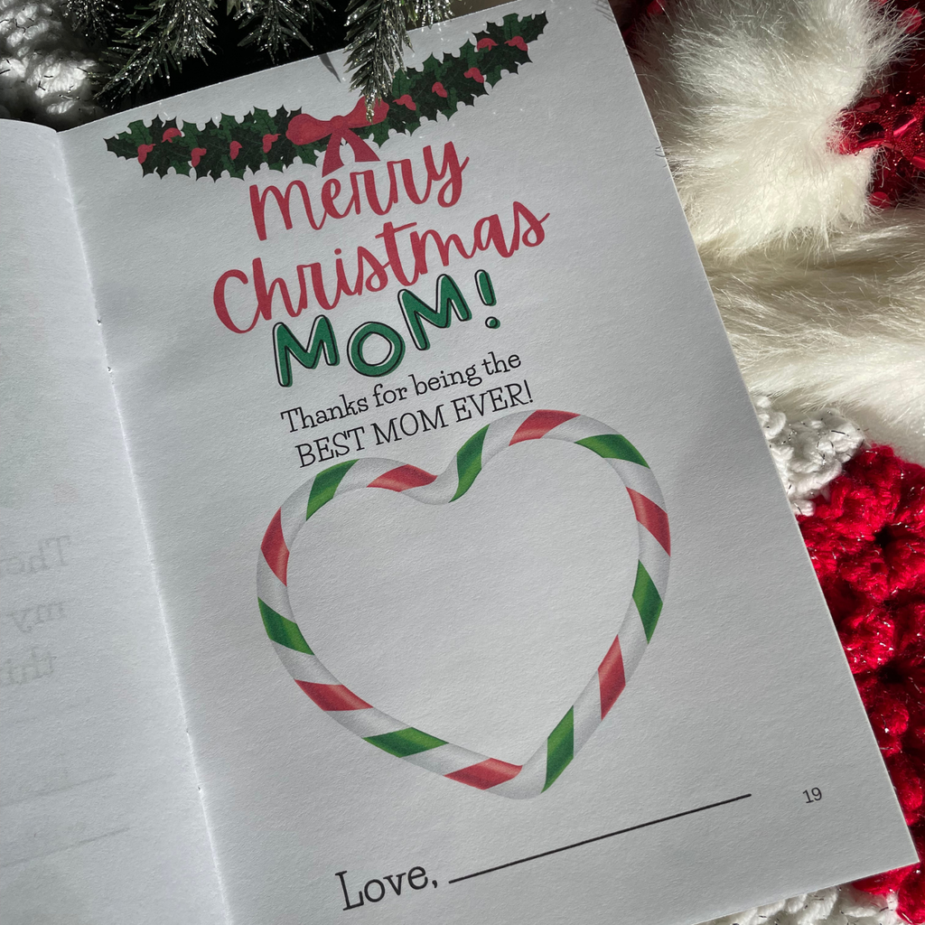 'Merry Christmas Mom' book interior page with festive illustrations on a background with snow, Christmas tree, presents and stocking