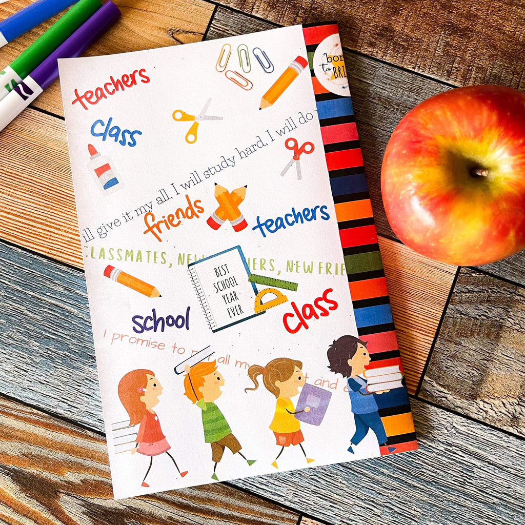Best School Year Ever back cover of kids Book on a table with an apple and kids markers for coloring