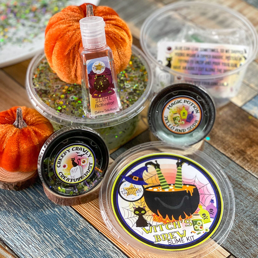 all ingredients in th diy slime kit for halloween. all ingredients are in there own container with labels of their own and it's on a table with orange pumpkins