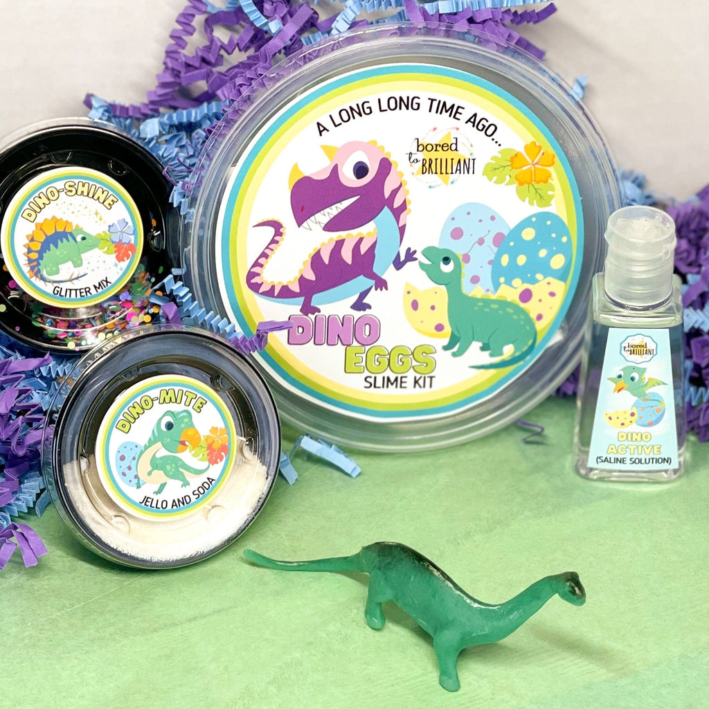 DINO EGGS BUTTER SLIME KIT ingredients on a table with a toy dinosaur