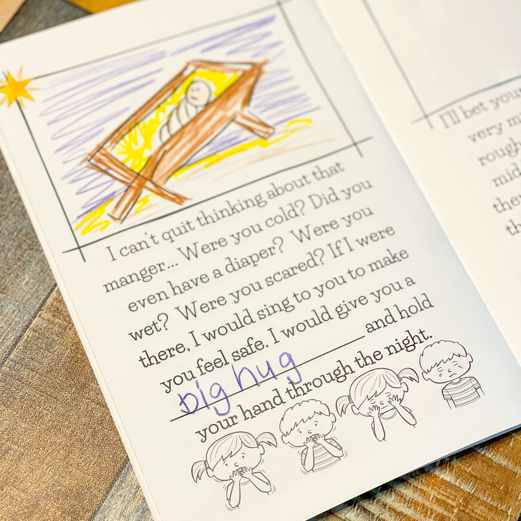 Best Nativity Story Ever Book open on a table showing inner page filled in with kids coloring picture they drew and words they wrote
