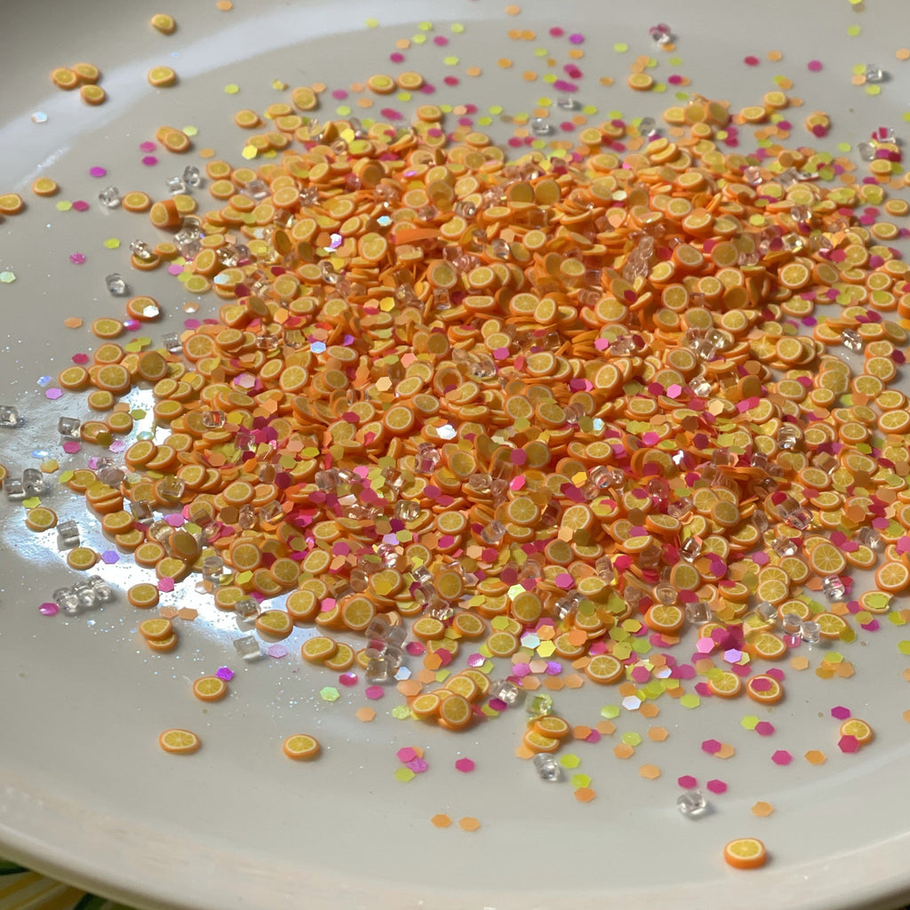 confetti that looks like tiny oranges and other colored confetti for the orange soda slime kit